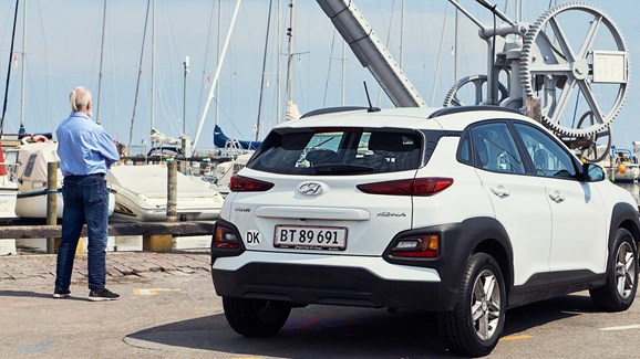 Hyundai-ejer stående ved siden af sin Hyundai KONA parkeret på havn 